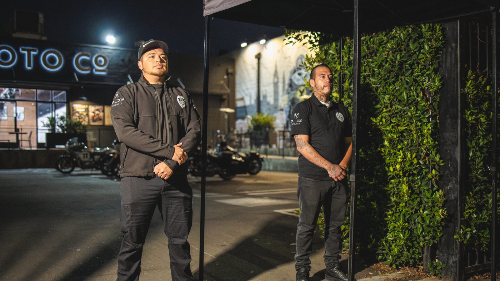 Two Valcor Security officers on post at night
